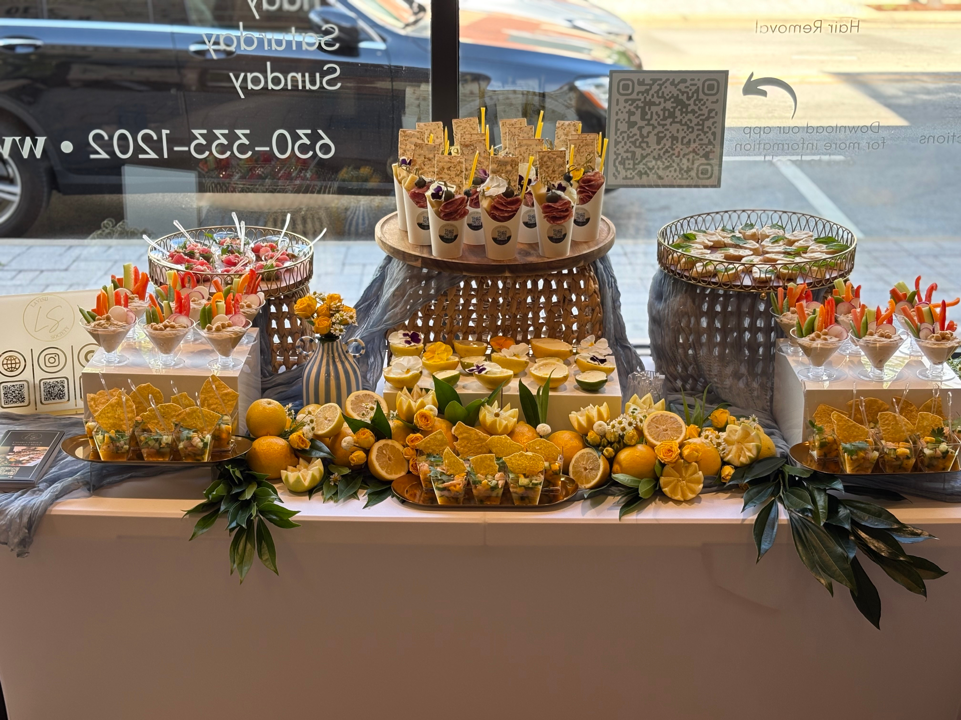 Citrus-themed grazing display with parfait cups, fruit platters, and lemon garnishes at a spa event