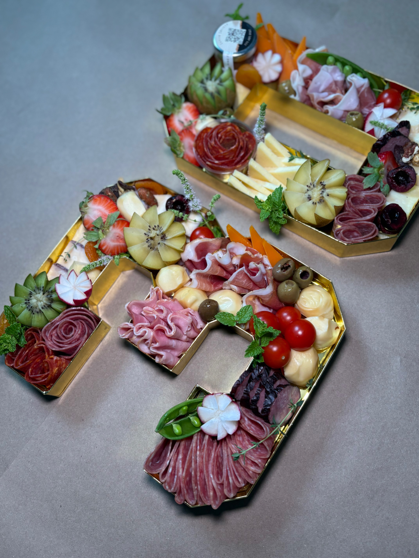 Number 30 charcuterie trays filled with cured meats, cheeses, and fruit for a birthday celebration